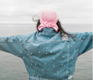 woman with arms outstretched after beating breast cancer