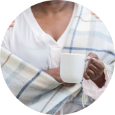 woman with blanket and mug as her comfot items after chemo