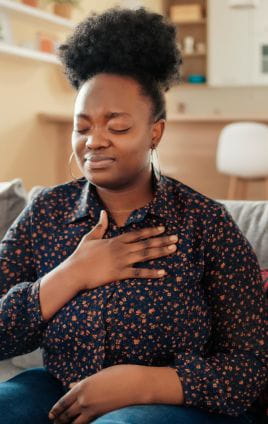 woman with her hand over her heart and lungs