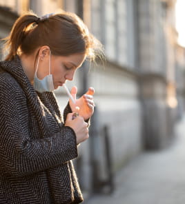 woman with mask pulled down so she can smoke