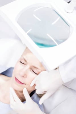 womans face being examined for skin cancer
