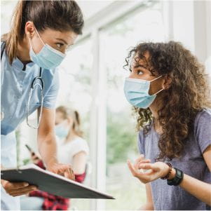 woman sharing visiting guidelines for Allina Health with a patient