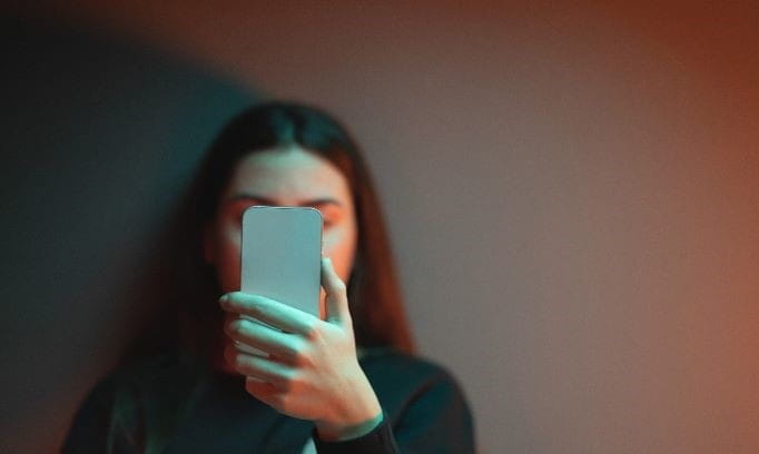 A woman holding a phone