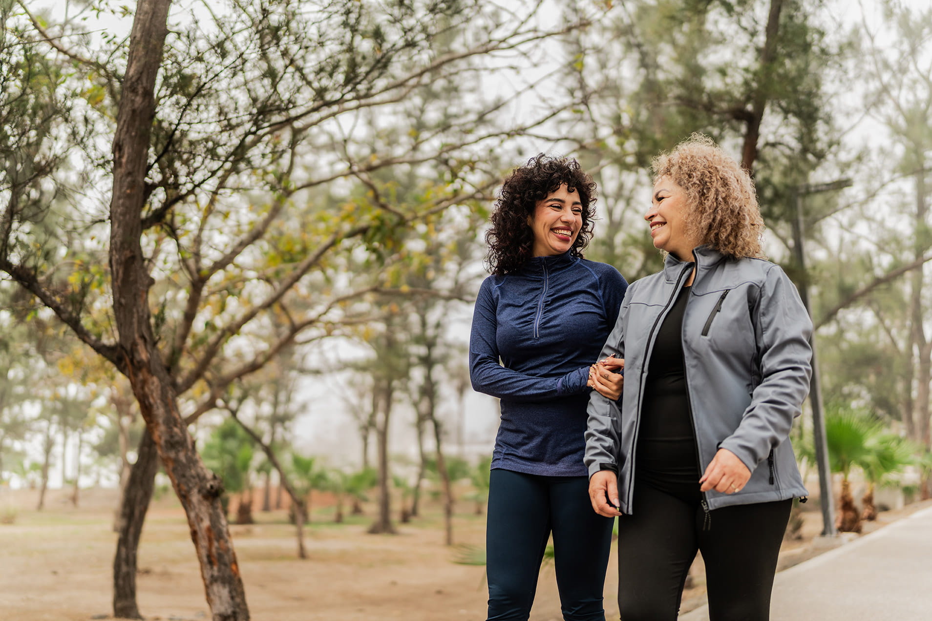 two women walking outdoors talking about colon cancer hereditary risk