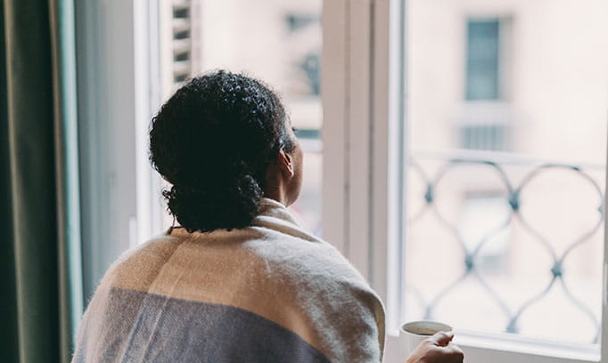 Woman outside through a window dealing with grief