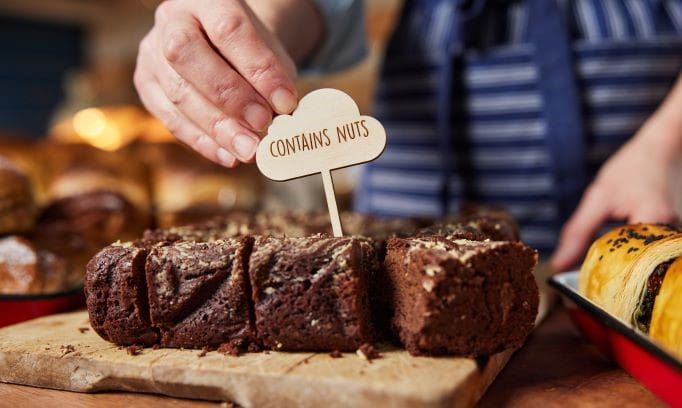 baked good with sign that says contains nuts indicating a food allergen