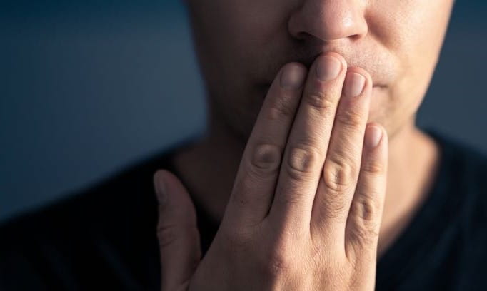 hand covering mouth that is stuttering