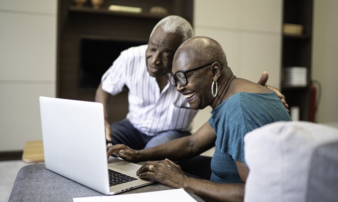 older black man and woman work on laptop computer filling out their health care directive