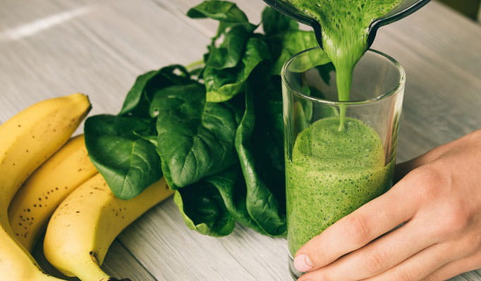 glass of healthier shamrock shake with bananas and spinach
