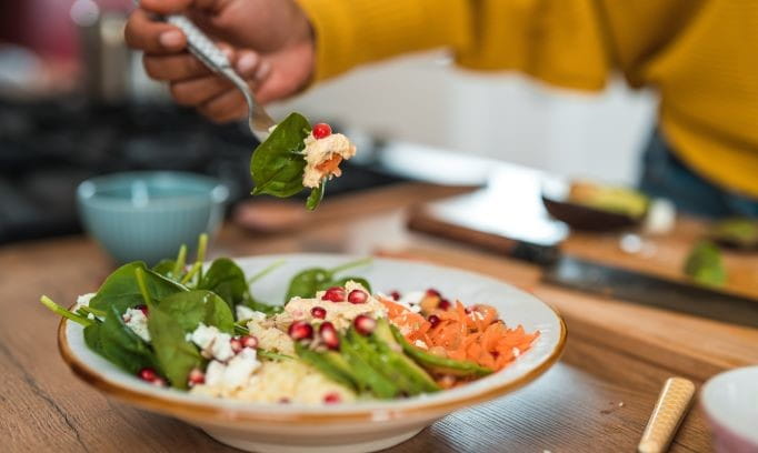 close-up of Mediterranean diet salad with avocado, feta and spinach 