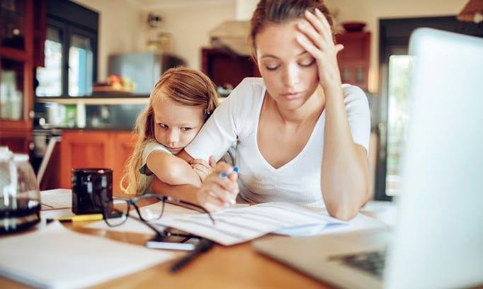 mother working from home with small daughter facing parental guilt 682x408