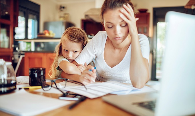 mother working from home with small daughter facing parental guilt 682x408