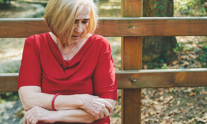 woman with rash on arm wondering if she has symptoms of shingles