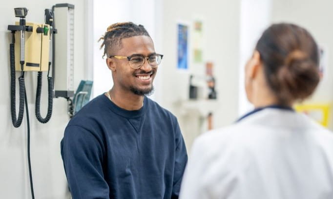 Patient speaks to a healthcare provider in an exam room about prostate cancer screening.