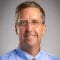 Doctor Todd Smith smiles for professional headshot.