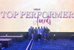 Group standing on stage at Visient awards